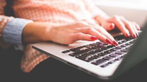 woman typing on laptop